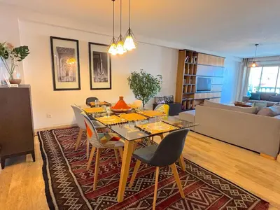a dining room with a table and chairs in a living room at Casa Sahifa in Casablanca