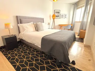 a bedroom with a large bed with a rug at Casa Sahifa in Casablanca