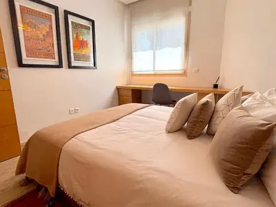a bedroom with a large white bed with a window at Casa Sahifa in Casablanca