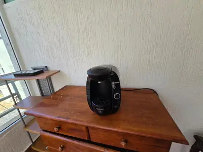 a black appliance sitting on top of a wooden table at Appartement cosy au centre de Casablanca in Casablanca