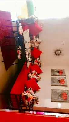 a room with red shelves with food on them at Appart avec piscine in Mohammedia
