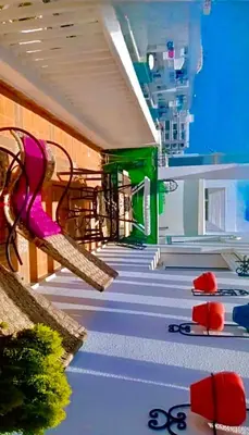 a hospital hallway with a pink chair and stairs at Appart avec piscine in Mohammedia