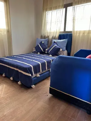 a blue bed in a room with a window at Ferme touristique domaine BENJDYA à HAD SOUALEM in Berrechid