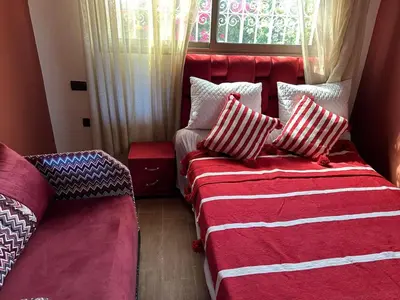 a bedroom with two beds with pillows and a window at Ferme touristique domaine BENJDYA à HAD SOUALEM in Berrechid
