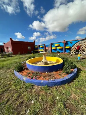 a fountain in the middle of a field at Ferme touristique domaine BENJDYA à HAD SOUALEM in Berrechid