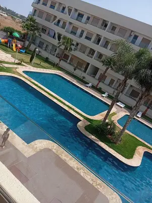 an overhead view of a swimming pool in front of a building at Two bedroom Apartment in Bouznika Beach in Bouznika