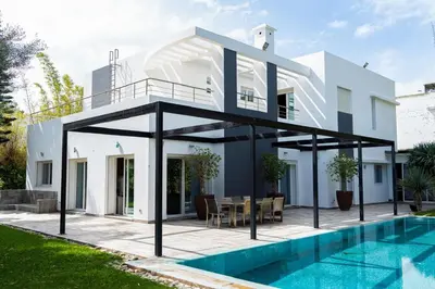 a villa with a swimming pool and a house at Bouskoura park in Bouskoura