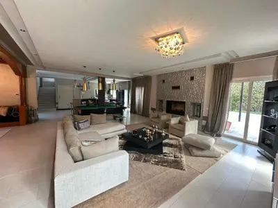 a large living room with couches and a pool table at Bouskoura park in Bouskoura
