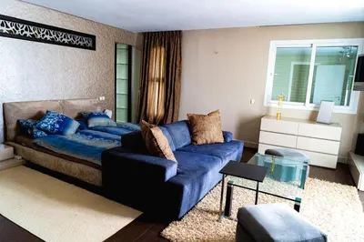 a living room with a couch and a blue sofa at Bouskoura park in Bouskoura