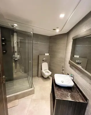 a bathroom with a toilet and a shower and a sink at Stylish 1BR in Racine - Prime Racine Location in Casablanca