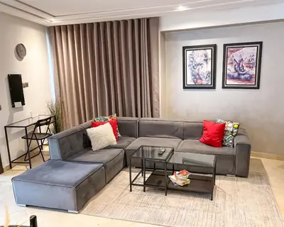 a living room with a gray couch and red pillows at Stylish 1BR in Racine - Prime Racine Location in Casablanca