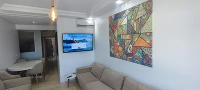 a living room with a couch and a painting on the wall at Confort & Style à Mohammedia parc in Mohammedia