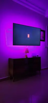 a purple room with a tv and a lamp in it at Appartement à côté de mosquée Hassan 2 et marina shopping in Casablanca