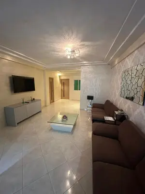 a living room with a couch and a tv at Appartement sidi rehal in Casablanca