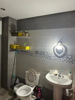 a bathroom with a toilet and a sink at Appartement sidi rehal in Casablanca
