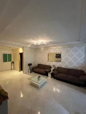 a living room with couches and a coffee table at Appartement sidi rehal in Casablanca