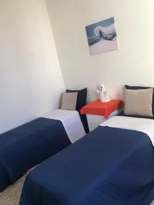 three beds in a room with blue and white at Chambre cosy en bord de mer in Mohammedia