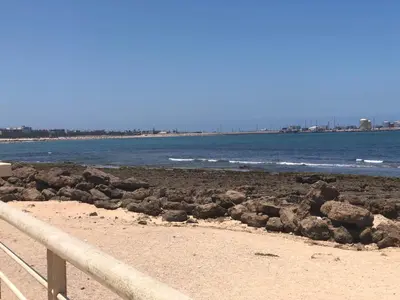 a beach with some rocks and the ocean at Chambre cosy en bord de mer in Mohammedia