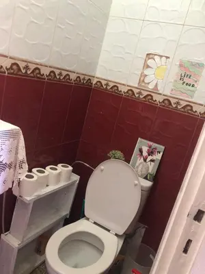 a bathroom with a toilet and a picture on the wall at Chambre cosy en bord de mer in Mohammedia