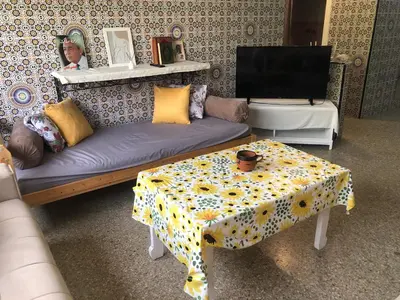 a living room with a couch and a table at Chambre cosy en bord de mer in Mohammedia
