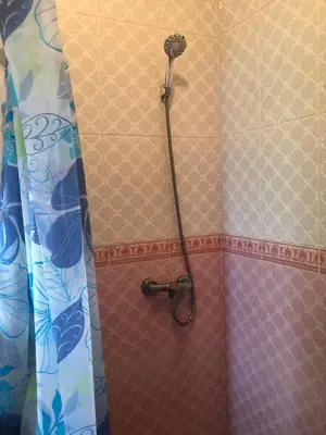 a shower with a shower head in a bathroom at Chambre cosy en bord de mer in Mohammedia