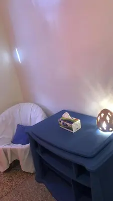 a blue table with a book on it next to a bed at Chambre cosy en bord de mer in Mohammedia