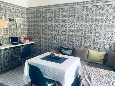 a living room with a table and a couch at Chambre cosy en bord de mer in Mohammedia