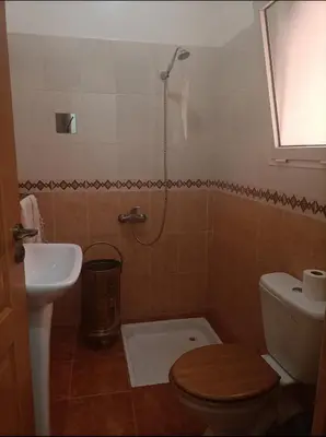 a bathroom with a toilet and a sink at Kasbah de bouznika, style Marrakech avec jardin et piscine in Kasba Bou Hamira