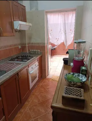 a kitchen with a counter with a bowl on a table at Kasbah de bouznika, style Marrakech avec jardin et piscine in Kasba Bou Hamira