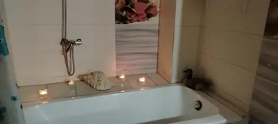 a white bath tub with lights in a bathroom at Appartement aéroport Mohammed 5 in Deroua