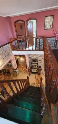 a spiral staircase in a house with a green floor at شاطئ مونيكا in Mohammedia