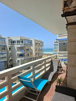 a balcony with chairs and a view of the beach at Appartement vu sur Mer in Mohammedia