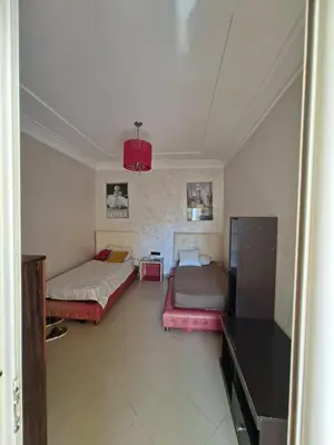 a living room with two beds and a table at Appartement vu sur Mer in Mohammedia