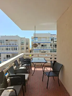 a balcony with chairs and tables on a building at Appartement vu sur Mer in Mohammedia