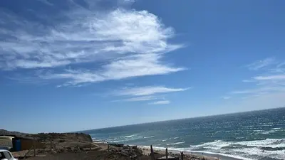 a view of the ocean with a cloudy sky at Bel appartement centre Asilah proche de la mer in Aïn Harrouda