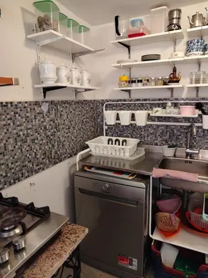 a kitchen with a sink and a stove at Cosy cabanon plage david in Kasba Bou Hamira