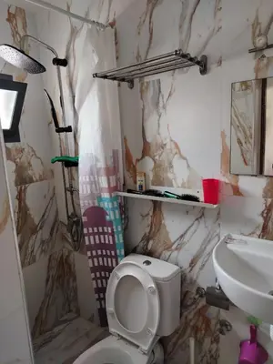 a bathroom with a toilet and a sink at Cosy cabanon plage david in Kasba Bou Hamira