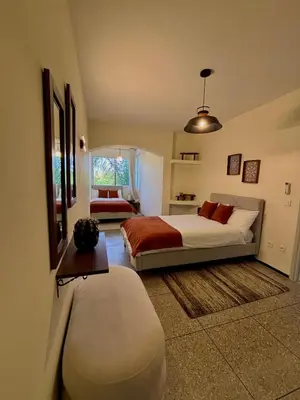 a bedroom with a bed and a bench and a window at Cozy Stay with Hassan Tower View in Rabat
