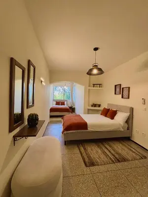 a large bedroom with two beds and a window at Cozy Stay with Hassan Tower View in Rabat