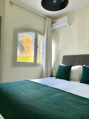 a bedroom with a large bed with a window at Cozy Stay with Hassan Tower View in Rabat
