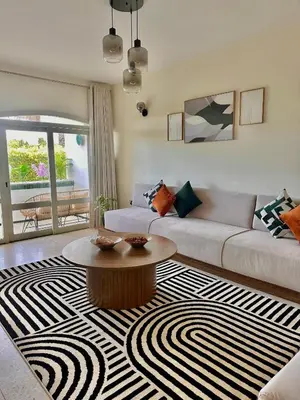 a living room with a couch and a coffee table at Cozy Stay with Hassan Tower View in Rabat