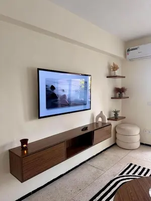 a living room with a flat screen tv on a wall at Cozy Stay with Hassan Tower View in Rabat