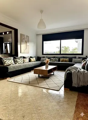 a living room with couches and a coffee table at Grand Appartement à Louer à Agdal, à Deux Pas de la Gare in Rabat