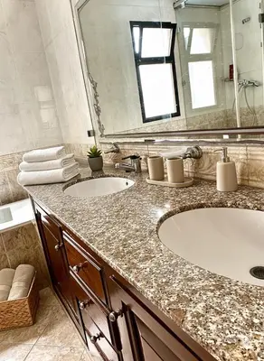 a bathroom with two sinks and a large mirror at Grand Appartement à Louer à Agdal, à Deux Pas de la Gare in Rabat