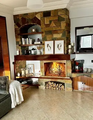 a fireplace in a living room with a stone wall at Grand Appartement à Louer à Agdal, à Deux Pas de la Gare in Rabat