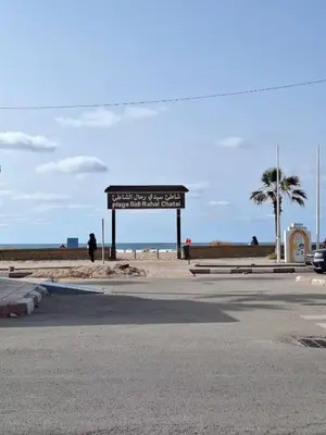 a sign on the side of a road near the beach at Sidi Rahal Appt raffiné, pieds dans l'eau in Sidi Rahal