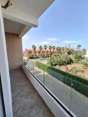 a balcony with a view of a street at Sidi Rahal Appt raffiné, pieds dans l'eau in Sidi Rahal
