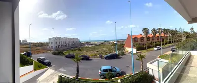 a view of a parking lot with cars parked in it at Sidi Rahal Appt raffiné, pieds dans l'eau in Sidi Rahal