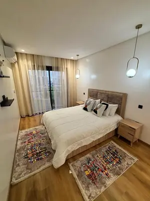 a bedroom with a large bed and a large window at Morostay in Casablanca