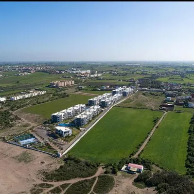 an aerial view of a city with houses and a field at Appartement Moderne très bien équipé pour familles seulement- Résidence Garden Bay Dar Bouazza in Tamaris